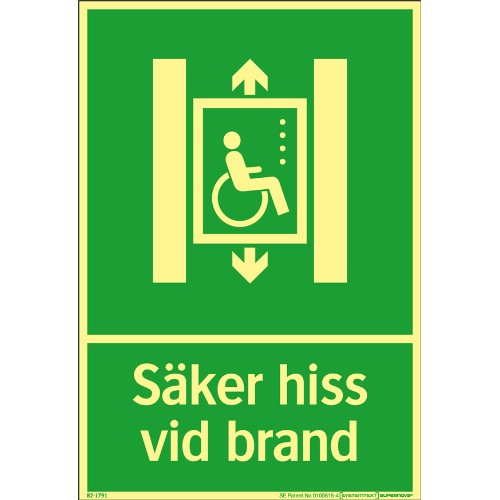 Skylt säker hiss vid brand Supernova färgefterlysande